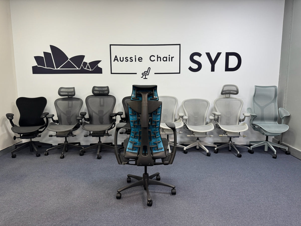 Herman Miller Embody Gaming in Black & Cyan in front of Aeron, Mirra and Cosm chairs at the Aussie Chair Sydney showroom